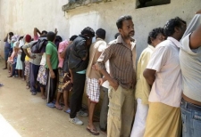 Sri Lankan asylum seekers who were sent back by Australia cover their faces as they wait to enter a magistrate's court in the southern port district of Galle July 8, 2014. File Photo